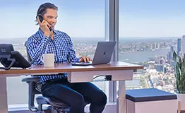 A client enjoys the comfort of a Dedicated Desk at Servcorp, TC Energy Center, Houston.